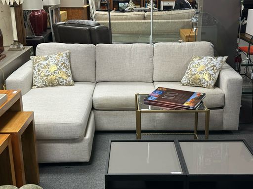 Stylish comfort meets smart storage with the Living Spaces Adjustable Storage Ottoman Sectional—customizable seating and hidden storage for modern living.